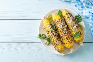 barbecue and grilled corn with cheese and lime photo