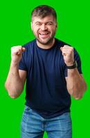A strong man with fists raised, smiling confidently, on a bright green background photo