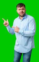 A man gesturing confidently with a bright green background photo