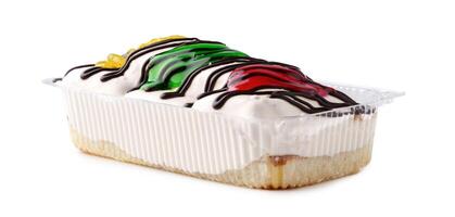 Delicious frozen dessert topped with colorful icing and drizzled chocolate in a clear container photo