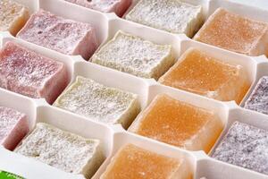 Colorful array of traditional sweets displayed in a structured tray for an afternoon treat photo