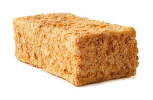Large rectangular block of sweet dessert made from crushed nuts and syrup displayed on white background photo