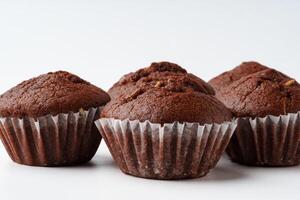Delicious chocolate muffins cooling on a white surface in a cozy kitchen setting photo