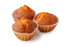 Golden brown mini muffins displayed in white paper liners, perfect for a delightful snack or dessert any time of day photo