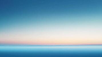 Soft pastel colors paint the sky above a calm ocean at dawn, creating a serene and tranquil atmosphere photo