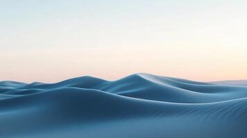 Sand dunes creating a wavy landscape under a clear sky during sunset photo