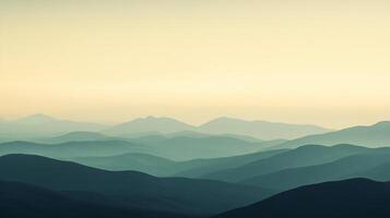 Stunning view of layers of mountains fading into the distance, creating a gradient effect under a warm sunset sky photo