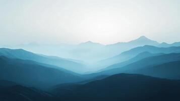 Layers of mountains fading into the distance with atmospheric perspective and a pale sky photo