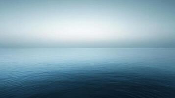Serene seascape with calm ocean water and a foggy horizon creating a peaceful and tranquil atmosphere photo