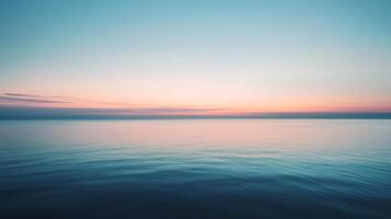 Tranquil ocean reflecting the vibrant colors of sunrise, creating a serene and peaceful atmosphere photo