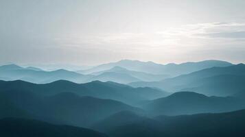 Stunning view of endless layers of blue mountains fading into the horizon under a pale sky photo