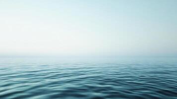 Tranquil turquoise water surface merging with misty sky creating a serene and minimalist seascape photo