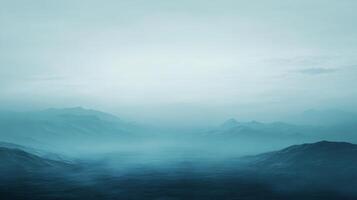 Surreal landscape with fog covering majestic blue mountains, creating a mysterious and evocative atmosphere photo