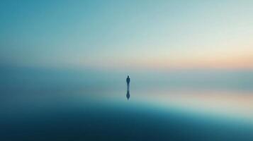 Silhouette of a lonely man standing on a water surface at sunset, reflecting in a minimalist surreal landscape, creating a sense of peace and solitude photo