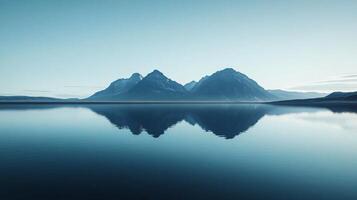 Serene landscape featuring snowy mountain peaks reflecting perfectly in a calm lake at sunrise, creating a tranquil and picturesque scene photo