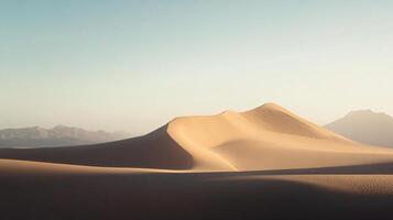 Beautiful untouched desert landscape with sand dunes and mountains in the background during a sunny day photo