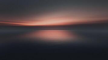 Minimalist seascape showing calm ocean reflecting orange sunset in cloudy sky photo