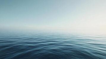 Tranquil ocean surface reflecting the soft colors of the sky, creating a serene and minimalist seascape at dawn photo