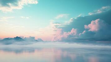 Beautiful sunset with mountains covered by fog reflecting on calm water with pink clouds and pastel colors photo