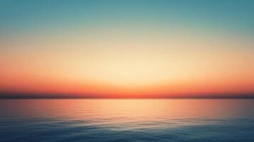 Tranquil ocean reflecting vibrant sunset colors during twilight, creating a serene and peaceful atmosphere photo