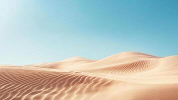 Windswept sand dunes form a mesmerizing pattern beneath a serene blue sky in a tranquil desert landscape photo