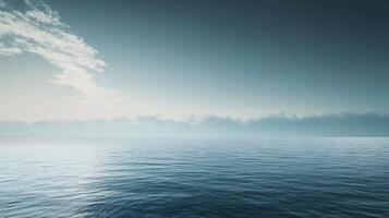 Serene seascape featuring calm ocean water, a misty horizon, and a cloudy sky during sunrise, creating a tranquil and atmospheric scene photo