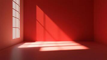 Empty red room corner illuminated by sunlight from large window, creating shadows on walls and floor photo