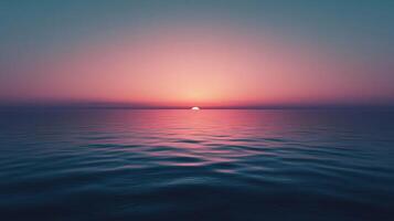 Breathtaking sunset over a calm ocean, creating a beautiful blend of pink and teal colors photo