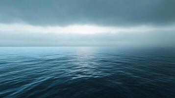 Low dark clouds covering the sky over a calm ocean, creating a gloomy and mysterious atmosphere photo