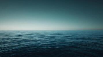 Deep blue ocean meeting a soft gradient sky at twilight, creating a tranquil and minimalist seascape photo