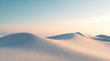 Rippled sand dunes bathed in the warm glow of the setting sun create a serene and minimalist desert landscape photo