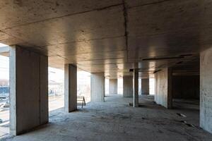 A currently vacant structure is presently under construction, showcasing robust concrete walls and durable pillars that clearly define the framework of the future space that will emerge photo