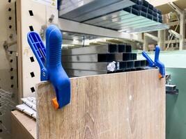 This scene showcases a woodworking setup complete with clamps holding a wooden panel securely in place for assembly inside a dedicated workshop environment photo