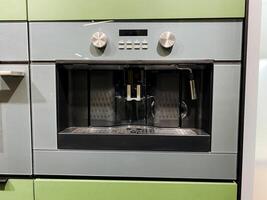 A coffee maker is conveniently built into the wall of a modern kitchen for easy access and a streamlined appearance, making it an essential kitchen appliance for coffee enthusiasts photo