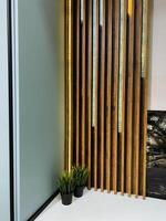 Imagine a cozy room featuring a beautiful wooden wall, complemented by two lovely potted plants gracefully positioned on the floor, adding a touch of nature to the space photo