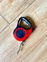 A striking red and black dog leash that has the number 11 printed on it photo