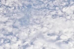 Fluffy white clouds texture on blue sky isolated on horizontal full frame background. photo