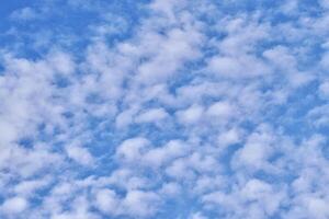 Calming blue sky with white clouds isolated on horizontal outdoor environment background. photo