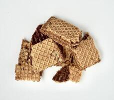 Group of crushed chocolate wafer biscuits isolated on horizontal white background from top angle view. photo