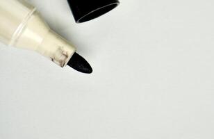 Opened permanent marker with black inked felt tip isolated on horizontal empty copy spaced white background. photo
