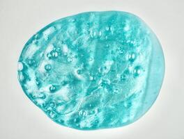 Blue stretchy slime toy object with bubbles texture isolated on horizontal white background. photo