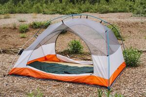 Immerse yourself in nature by camping in a colorful tent perfect for adventure lovers seeking a deep connection with the wilderness and a peaceful escape into the outdoors photo