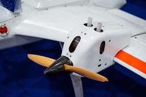 This is a detailed closeup image of a meticulously crafted model airplane featuring a classic propeller, showcasing the intricate design and precision involved in its construction photo