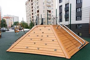 A contemporary wooden climbing structure designed for use in an urban playground setting, enhancing leisure activities photo