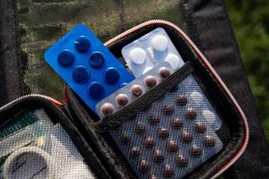 A wellequipped first aid kit is essential for emergencies, containing various pills, medications, and supplies to effectively address potential health issues in different situations photo
