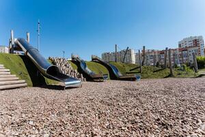 The playground features a diverse range of slides and stairs, providing kids with an engaging and enjoyable space to play and interact, promoting fun and positive experiences photo