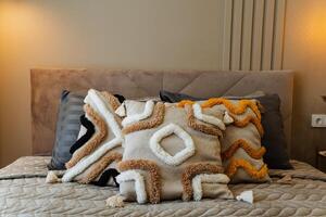 In a warm and cozy bedroom, there exists a sumptuous bed adorned with soft, fluffy pillows that create a plush atmosphere perfect for achieving ultimate relaxation and restful sleep photo