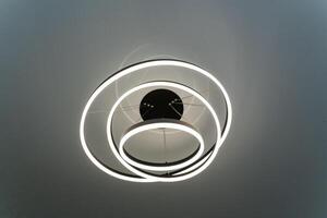 This is a close up view of a circular light fixture mounted on a ceiling photo