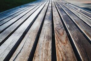 This image features a closeup view of a beautifully crafted wooden deck that showcases a striking diagonal pattern, emphasizing the unique textures and hues of the wood surface photo