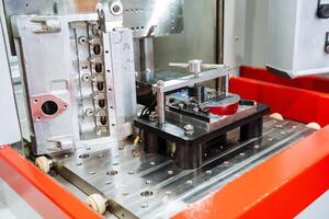 In a factory setting, a machine is effectively working on a particular piece of metal, engaging in various tasks that may differ based on its intended application across numerous industries photo